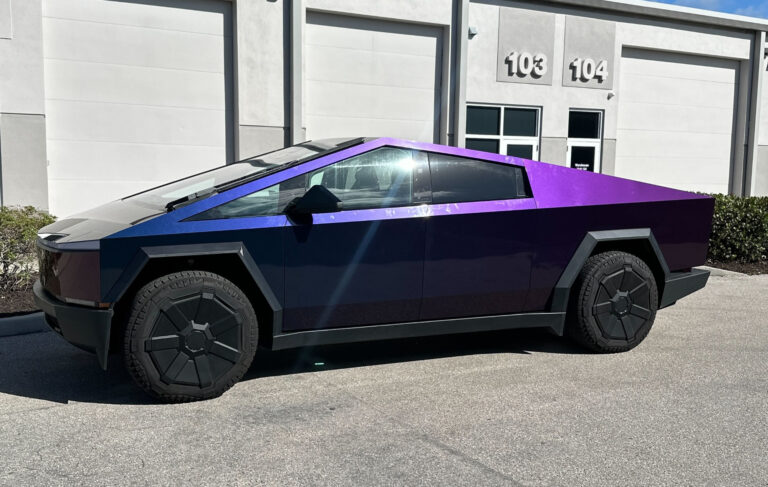 A vibrant purple and black electric vehicle displayed prominently, highlighting its contemporary aesthetics and eco-friendly appeal