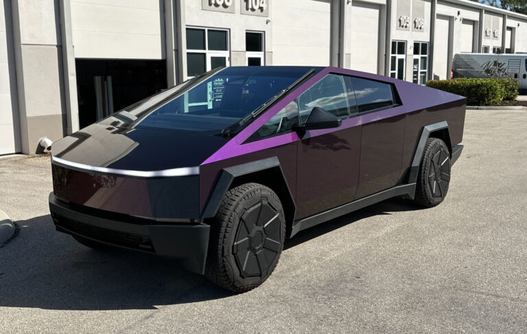 A striking electric vehicle in purple and black, emphasizing its innovative design and sustainable technology in a city setting