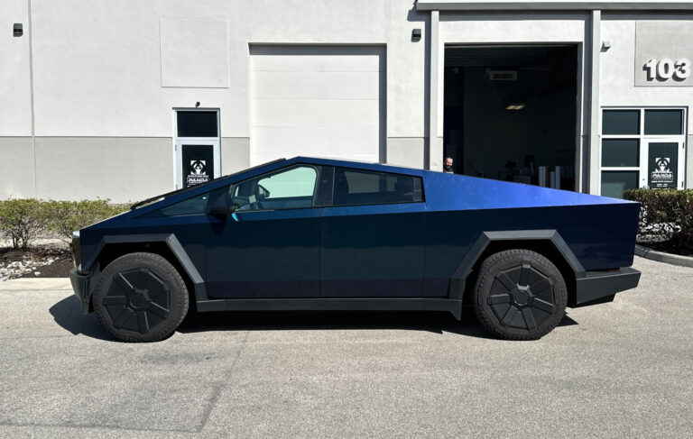 A parked electric vehicle positioned in front of a contemporary building, highlighting eco-friendly commuting options